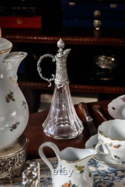 A cryistal carafe with pewter lid