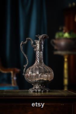 An 19th century silver plated and crystal carafe