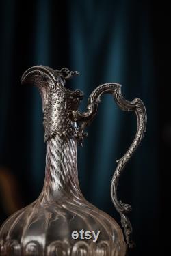 An 19th century silver plated and crystal carafe