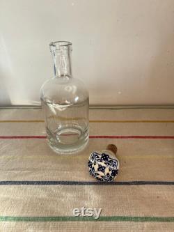 An elegant versatile French 37.5 cl capacity glass, carafe, bottle with a ceramic blue and white push in cork stopper