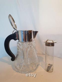 Beautiful heavy juice jug of beautifully cut crystal with engravings. Complete with cooler and strainer.