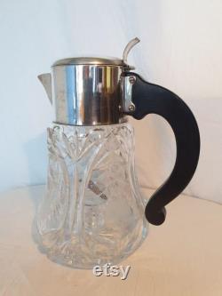 Beautiful heavy juice jug of beautifully cut crystal with engravings. Complete with cooler and strainer.