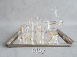 Glass carafe with glasses and mirror tray