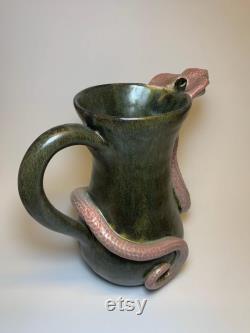 Hamdmade ceramic carafe with snake.