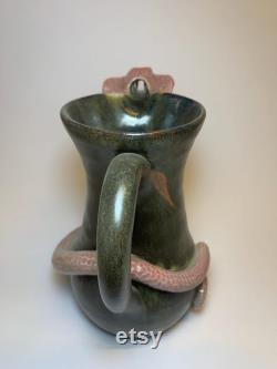 Hamdmade ceramic carafe with snake.