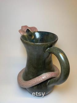 Hamdmade ceramic carafe with snake.