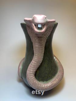 Hamdmade ceramic carafe with snake.