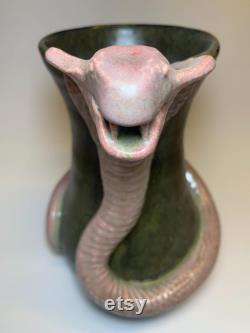 Hamdmade ceramic carafe with snake.