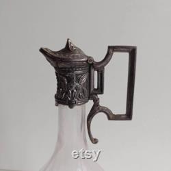 Small Art Nouveau pewter Empire style with eagle relief decoration and faceted glass carafe with maker's stamps.