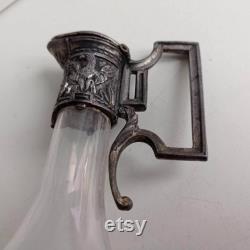 Small Art Nouveau pewter Empire style with eagle relief decoration and faceted glass carafe with maker's stamps.